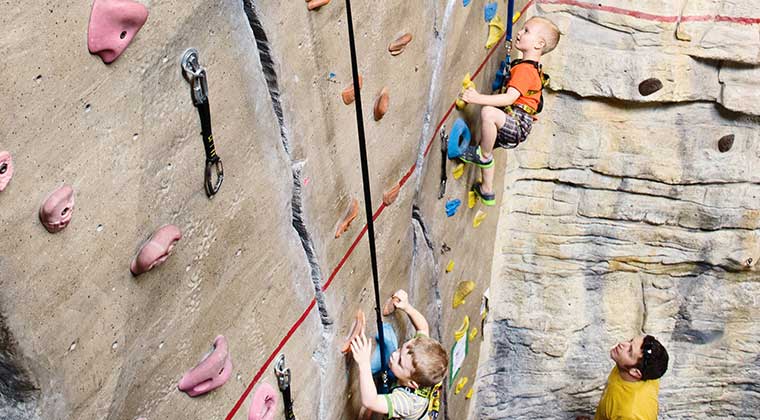 kids on an indoor climbing wall