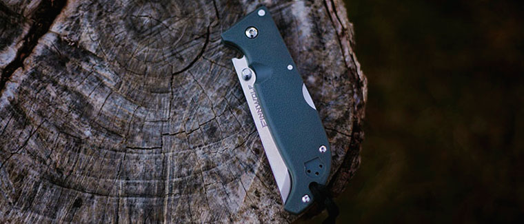 pocket knife sitting on rock