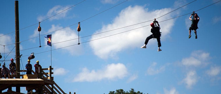 riders approaching zip line brake