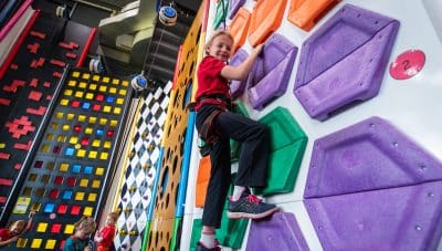 Girl climbs TRUBLUE auto belay at Family Entertainment Center