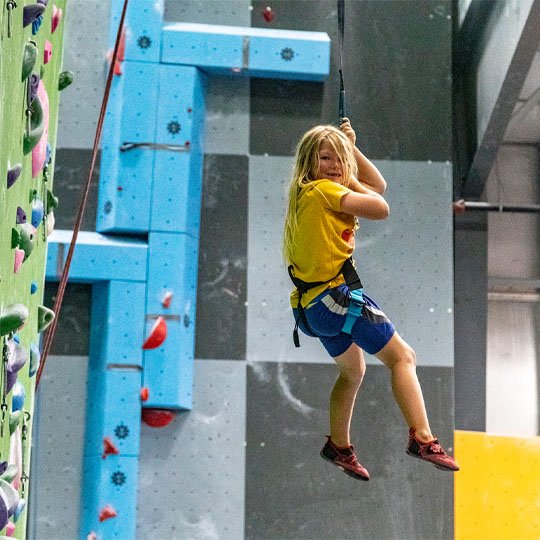 Girl lowering on TRUBLUE auto belay